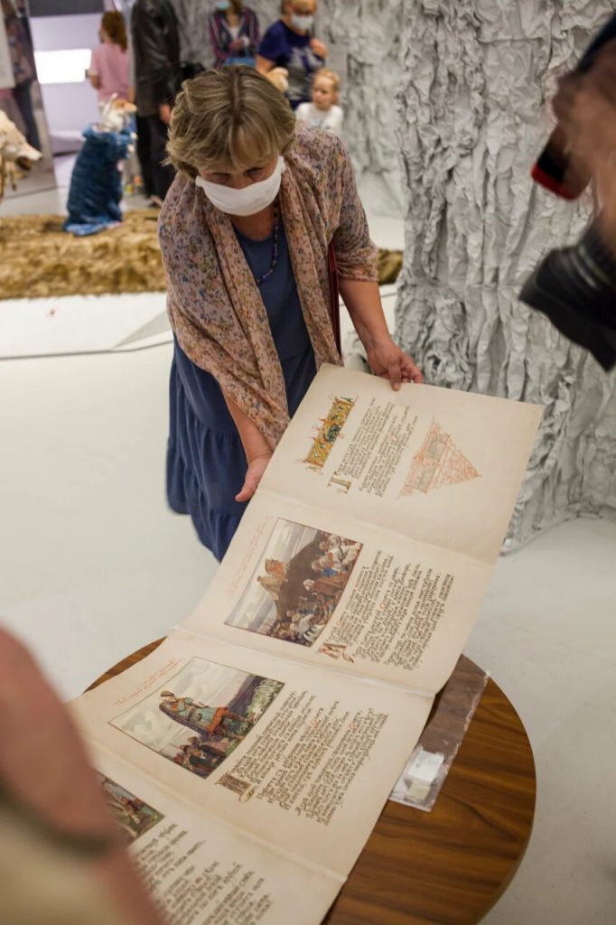 old manuscript handled by museum worker